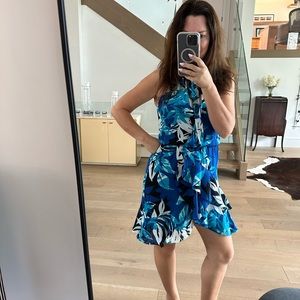 Parker multi blue, some black and white, ruffled dress with tie at the neck.